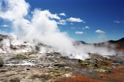 Image of steam rising over geothermal field