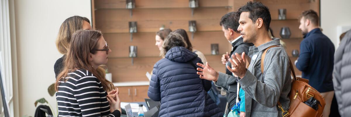 People in discussion in the lobby of a Climate One event