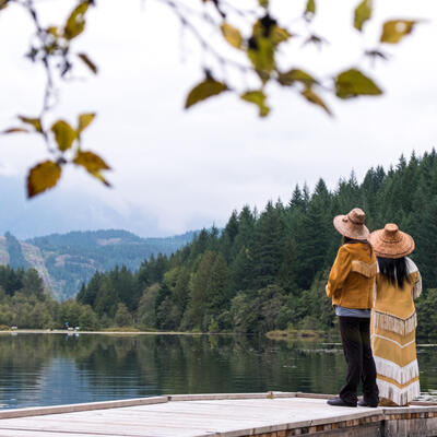 people on dock by lake