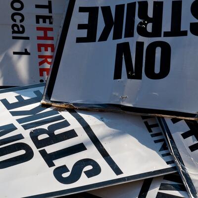 A pile of picket signs from a strike by UNITE HERE Local 1