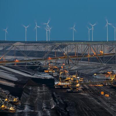 Windmills on a hill overlooking a coal mine