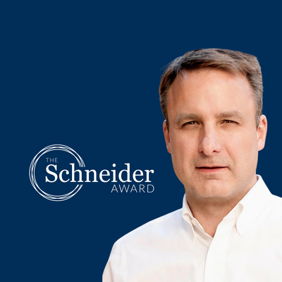 Jonathan Foley against a dark blue background with the Schneider Award logo to his left