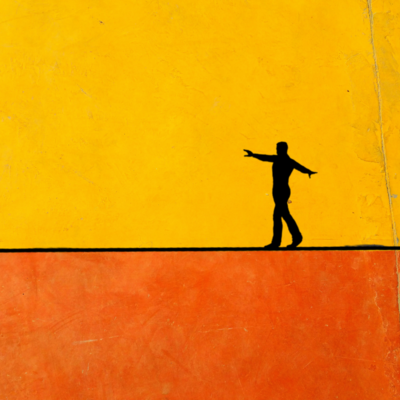 silhouette of a person walking on a tightrope, against a yellow and orange background
